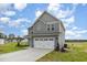 Beautiful home featuring a well-manicured lawn and a convenient two-car garage at 53 Barony Ln, Smithfield, NC 27577