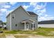 This is an exterior view of a two story home with gray siding and a back porch and yard at 53 Barony Ln, Smithfield, NC 27577