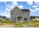 This is an exterior view of a two story home with gray siding and a back porch and yard at 53 Barony Ln, Smithfield, NC 27577