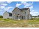 This is an exterior view of a two story home with gray siding and a back porch and yard at 53 Barony Ln, Smithfield, NC 27577