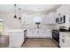 Modern kitchen featuring white cabinets, stainless steel appliances, and breakfast bar at 53 Barony Ln, Smithfield, NC 27577