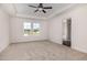 This bedroom has plush carpeting, a ceiling fan, and plenty of natural light at 53 Barony Ln, Smithfield, NC 27577