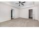 This bedroom has neutral paint, a ceiling fan, and two entrances to the bathrooms or closets at 53 Barony Ln, Smithfield, NC 27577