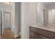 Neutral toned bathroom with a dark vanity and a view to the shower at 54 Barony Ln, Smithfield, NC 27577
