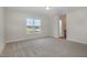 Neutral-toned bedroom with a large window with views to neighborhood and carpet floors at 54 Barony Ln, Smithfield, NC 27577