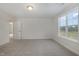 Neutral-toned bedroom with a large window with views to neighborhood and carpet floors at 54 Barony Ln, Smithfield, NC 27577