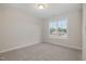 Cozy bedroom with neutral carpet and a large window with neighborhood views at 54 Barony Ln, Smithfield, NC 27577