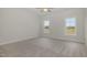 Bright bedroom with neutral carpet, a ceiling fan, and two windows offering ample natural light at 54 Barony Ln, Smithfield, NC 27577