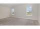 The bright bedroom features neutral carpet, light-filled windows and neutral paint at 54 Barony Ln, Smithfield, NC 27577