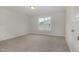 A cozy bedroom features neutral walls, plush carpet and a sun-filled window at 54 Barony Ln, Smithfield, NC 27577