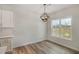 Bright dining area with hardwood floors and a view of the backyard through a large window at 54 Barony Ln, Smithfield, NC 27577