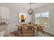 Bright dining area featuring a round table with seating for four and a stylish globe chandelier at 54 Barony Ln, Smithfield, NC 27577