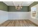 Elegant dining room with wainscoting, modern chandelier, and hardwood floors for upscale dining at 54 Barony Ln, Smithfield, NC 27577