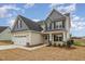 Beautiful two-story home featuring a two-car garage, gabled roof, and professionally landscaped front yard at 54 Barony Ln, Smithfield, NC 27577