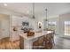 Modern kitchen featuring an island with quartz countertops, bar stool seating, and stainless steel appliances at 54 Barony Ln, Smithfield, NC 27577