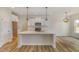 Open kitchen with white cabinets, stainless steel appliances, and a large island with ample counter space at 54 Barony Ln, Smithfield, NC 27577