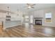 Open concept living space with a fireplace, wood floors, and access to the kitchen and backyard at 54 Barony Ln, Smithfield, NC 27577