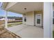 A covered porch has an exterior door, window and concrete flooring at 54 Barony Ln, Smithfield, NC 27577