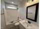 Bathroom with a shower-tub combo, dark hardware, and a vanity with a white countertop and sink at 56 Bailey-Boykin Rd, Selma, NC 27576