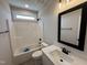 Bathroom with a single sink vanity, framed mirror, and shower/tub combo with black fixtures at 56 Bailey-Boykin Rd, Selma, NC 27576