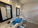 Double vanity bathroom featuring black framed mirrors, a toilet, and a shower with glass doors at 56 Bailey-Boykin Rd, Selma, NC 27576