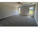 Large, bright bedroom with tray ceilings, ceiling fan, and plush carpet at 56 Bailey-Boykin Rd, Selma, NC 27576