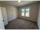Cozy bedroom with neutral walls and carpet, and a bright window at 56 Bailey-Boykin Rd, Selma, NC 27576