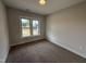 Bedroom with neutral paint, carpet, and a double window offering a view of the outdoors at 56 Bailey-Boykin Rd, Selma, NC 27576