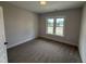 A carpeted bedroom with a double window providing natural light, perfect for a cozy retreat at 56 Bailey-Boykin Rd, Selma, NC 27576