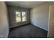 Neutral bedroom featuring plush gray carpeting and abundant natural light from a large window at 56 Bailey-Boykin Rd, Selma, NC 27576