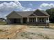 A charming one-story home with a light green exterior, covered porch, and an attached two-car garage at 56 Bailey-Boykin Rd, Selma, NC 27576
