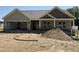New construction home featuring a light green exterior, gray roof, and an open garage at 56 Bailey-Boykin Rd, Selma, NC 27576