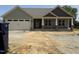 New construction home featuring a front porch with craftsman style pillars and attached two-car garage at 56 Bailey-Boykin Rd, Selma, NC 27576