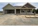 Charming exterior view of a single-story home with an attached two-car garage on a partly cloudy day at 56 Bailey-Boykin Rd, Selma, NC 27576