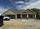 New construction shows a charming one-story home with stone accents and a two-car garage at 56 Bailey-Boykin Rd, Selma, NC 27576