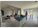 Bright kitchen with white cabinets and a blue island under construction within open-concept room at 56 Bailey-Boykin Rd, Selma, NC 27576