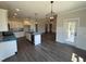 Spacious kitchen with white cabinets, a center island, and stainless steel appliances at 56 Bailey-Boykin Rd, Selma, NC 27576
