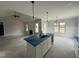 Open-concept kitchen island with sink, view to fireplace and living area in a bright open floor plan at 56 Bailey-Boykin Rd, Selma, NC 27576