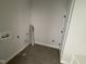 Clean, white laundry room with tile floors and necessary connections for washer and dryer at 56 Bailey-Boykin Rd, Selma, NC 27576