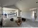 Open-concept living room and kitchen with white cabinets and a vaulted ceiling under construction at 56 Bailey-Boykin Rd, Selma, NC 27576