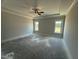 Main bedroom featuring a tray ceiling with fan and two windows for natural light at 56 Bailey-Boykin Rd, Selma, NC 27576