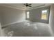 Main bedroom with tray ceiling and natural light with large windows at 56 Bailey-Boykin Rd, Selma, NC 27576