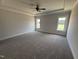 The main bedroom is spacious and features a tray ceiling and large windows at 56 Bailey-Boykin Rd, Selma, NC 27576
