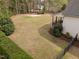 Large backyard with privacy fence, manicured lawn, and a basketball court at 5928 Terrington Ln, Raleigh, NC 27606