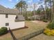Spacious backyard featuring grass, trees, bushes, privacy fence, and basketball court at 5928 Terrington Ln, Raleigh, NC 27606