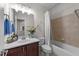 A full bathroom with shower and tub combination, decorated with flowers at 5928 Terrington Ln, Raleigh, NC 27606