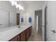 Bathroom with a cherry vanity, bright white counter and a large mirror at 5928 Terrington Ln, Raleigh, NC 27606