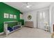 Bright Bedroom with green accent wall, crib, changing table and neutral carpet at 5928 Terrington Ln, Raleigh, NC 27606