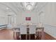 Formal dining room with coffered ceiling, hardwood floors, and stylish chandelier at 5928 Terrington Ln, Raleigh, NC 27606