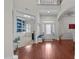 Open foyer with hardwood floors, white wainscoting, and an adjacent study and dining room at 5928 Terrington Ln, Raleigh, NC 27606